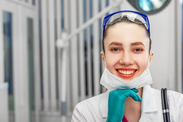 close-up-female-doctor-taking-off-mask-smiling-camera-background-hospital-ward-gambling-disease-virus-covid-19-recovery-good-news-from-medical-professionals_124865-9815